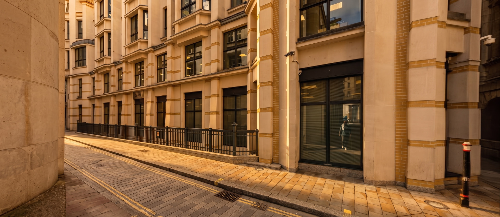 Stone-faced commercial building on Mansion House Place, City of London, at golden hour